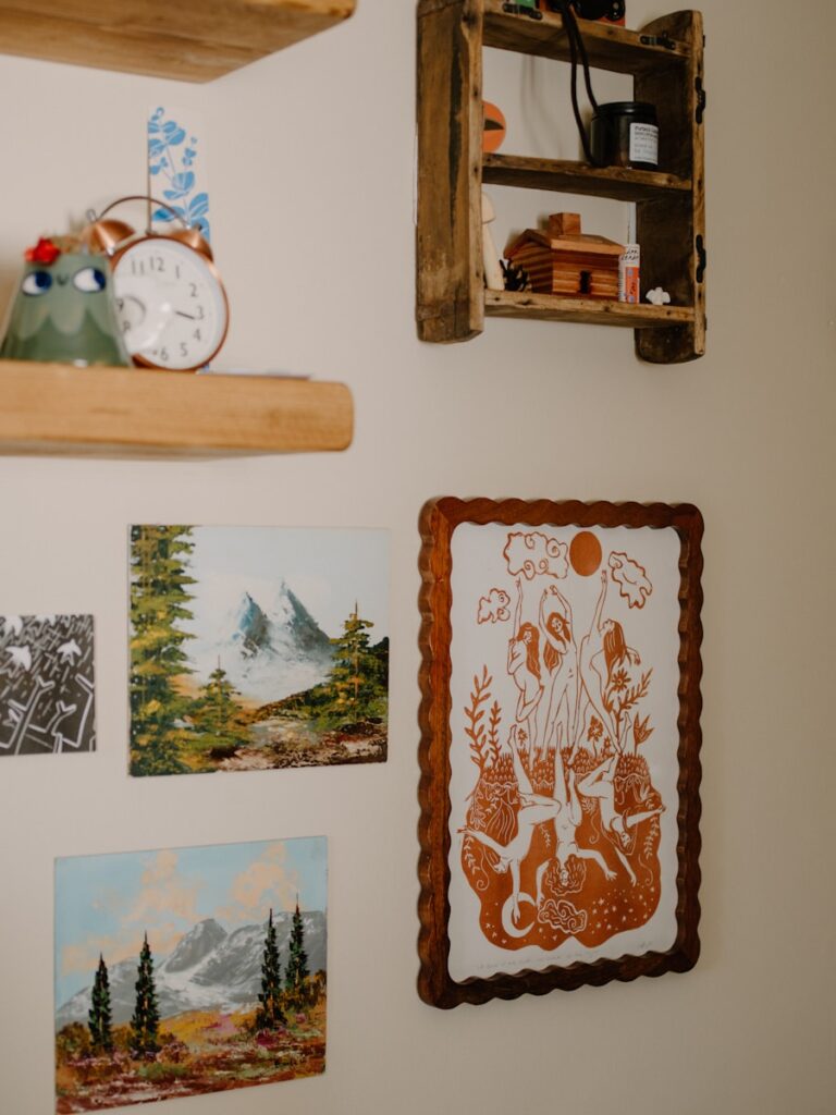 Wall art including paintings and a framed illustration.