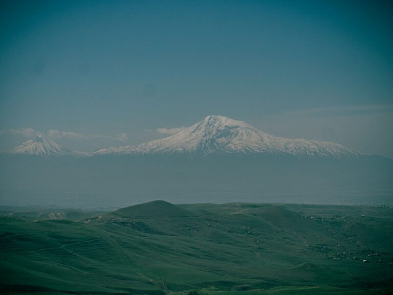 a large snow covered mountain in the distance