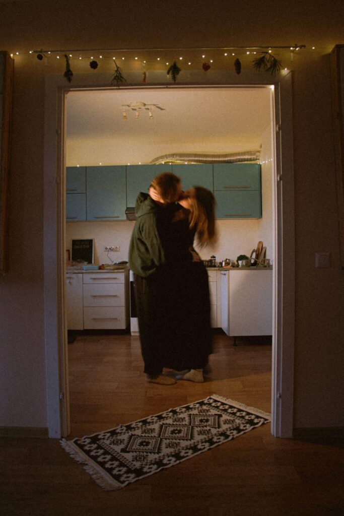 Couple embracing in a dimly lit kitchen