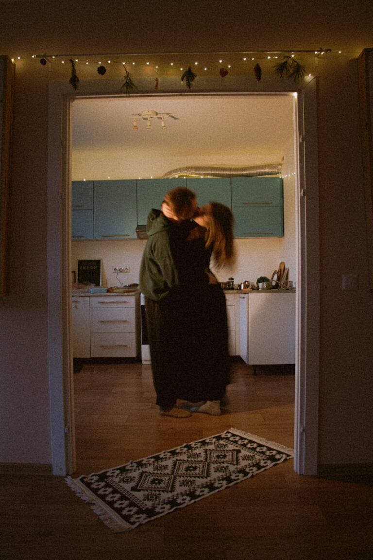 Couple embracing in a dimly lit kitchen